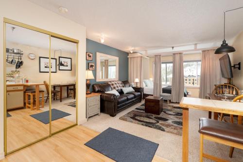 a living room with a couch and a table and a kitchen at Snowblaze E102 Studio in Winter Park