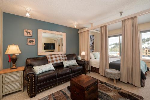 a living room with a couch and a bedroom at Snowblaze E102 Studio in Winter Park