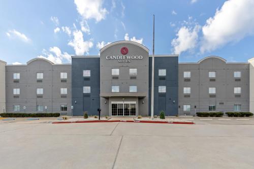 a building with a sign on the front of it at Candlewood Suites Victoria by IHG in Victoria