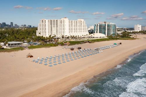 an aerial view of a beach with umbrellas and chairs at Fort Lauderdale Marriott Harbor Beach Resort & Spa in Fort Lauderdale