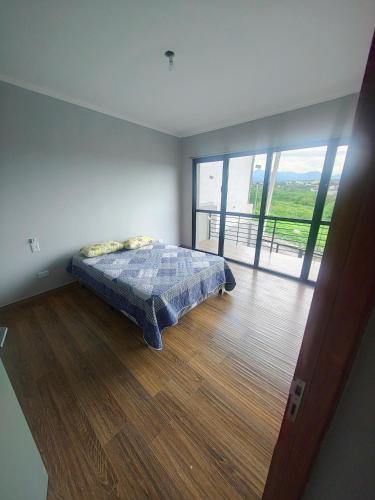 a bedroom with a bed and a large window at Triplex con vista hermosa in Salta