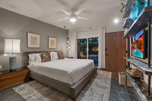 a bedroom with a bed and a tv at Speakeasy Hotel in Palm Springs