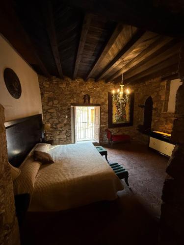 a bedroom with a large bed in a stone building at Hotel Ruinas Del Real in Real de Catorce