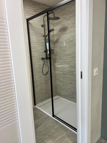 a shower with a glass door in a bathroom at La Casita in Ardales