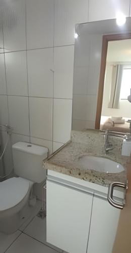 a white bathroom with a toilet and a sink at Apartamento Completo 608 Monte Fuji, Praia de Cabo Branco in João Pessoa