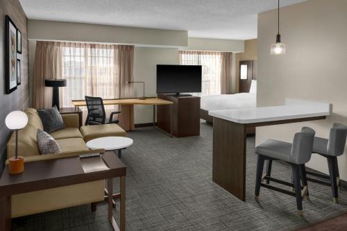 a hotel room with a couch and a bed at Residence Inn by Marriott Albuquerque North in Albuquerque