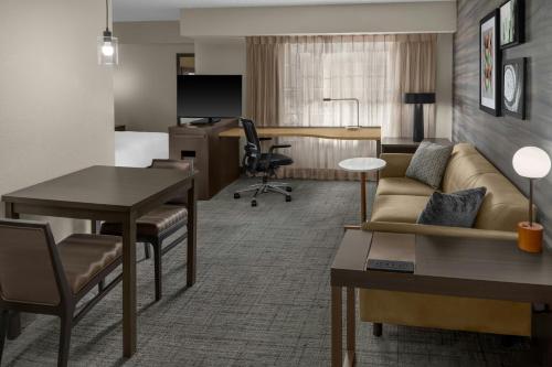 a living room with a couch and a desk at Residence Inn by Marriott Albuquerque North in Albuquerque