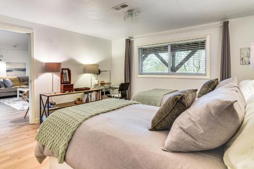 a bedroom with a bed and a desk and a window at 3 Mi to Downtown Portland Lush Flat with Fire Pit in Portland