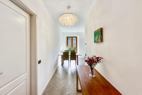 a hallway with a vase of flowers on a wooden table at Lenno Centrale in Lenno