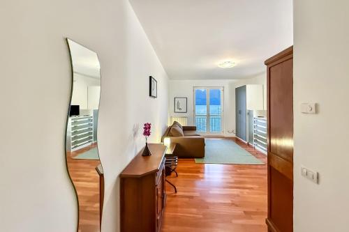 a living room with a staircase and a mirror at Residenza Menaggio - Mimosa in Menaggio