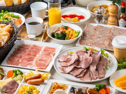 a table with many plates of food on it at APA Hotel Shinjuku Kabukicho Tower in Tokyo