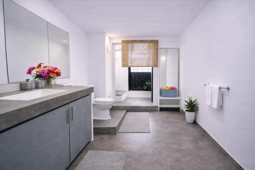 a white bathroom with a sink and a toilet at 519@jamtree in Colombo