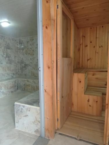 a sauna with wood walls and marble floors at Mountain View Finca Campestre in Manizales