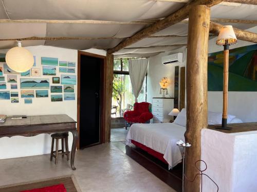 a bedroom with a bed and a desk at Oca House in Búzios