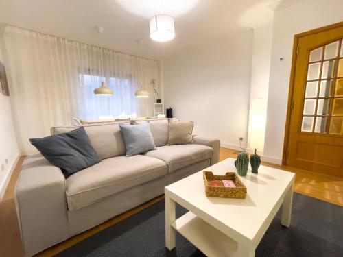 a living room with a couch and a table at Apartment near Sintra and Lisbon in Belas
