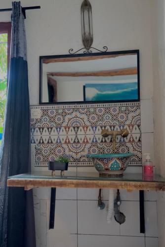 a bathroom with a sink and a mirror at Chiwash Place Taghazout in Taghazout