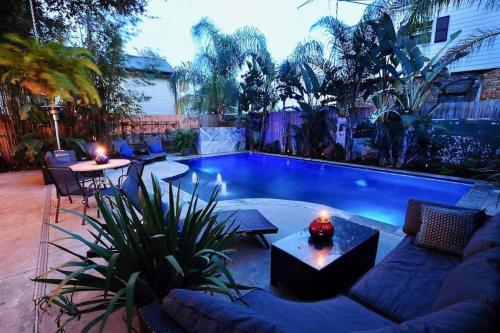 a backyard with a pool with a couch and tables at Historic- Salt Pool-Balconies-Near French Quarter in New Orleans