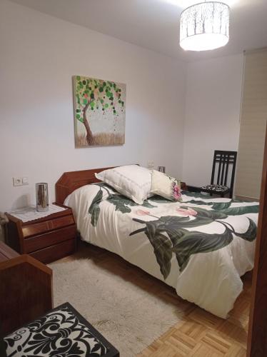 a bedroom with a bed and a table and a lamp at CUATRO CAMINOS in Zamora