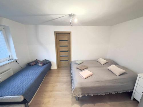 a bedroom with two beds and a window at Apartmán Buky in Mladé Buky