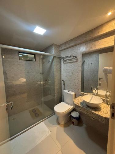 a bathroom with a toilet and a sink and a shower at Flat Gold Sea View - Tabatinga Beach in Conde