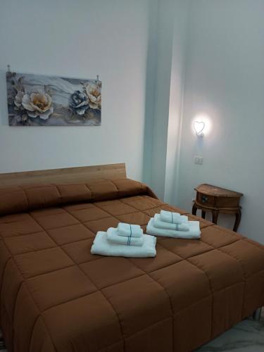 a bedroom with a bed with two towels on it at LETIZIA'S HOME Caserta in Caserta