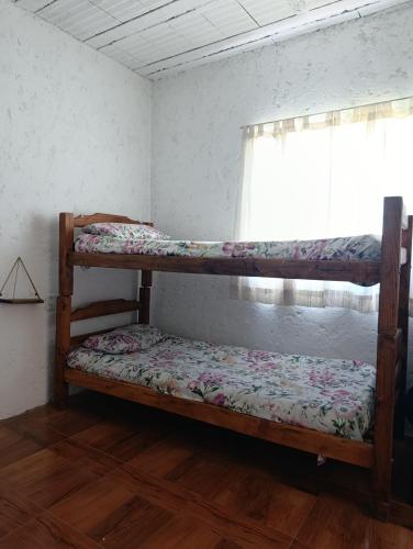 two bunk beds in a room with a window at La Morada de sus Sueños Caeiro in Bialet Massé
