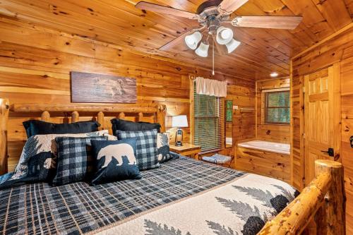 a bedroom with a bed and a ceiling fan at A Bear's view in Sevierville