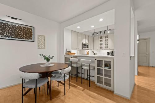 a kitchen and dining room with a table and chairs at Seattle Waterfront Condo - Walk Up Steps to Pike Place in Seattle