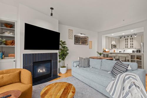 a living room with a couch and a fireplace at Seattle Waterfront Condo - Walk Up Steps to Pike Place in Seattle