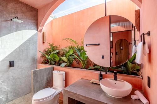 a bathroom with a sink and a mirror at Amplitude Coliving in Brisas de Zicatela