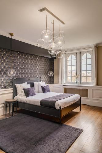 a bedroom with a large bed in a room at Hotel Ô Château in Hayange