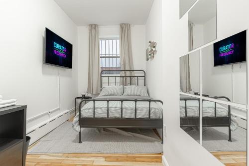 a bedroom with two bunk beds and a tv at Modern Comfort 2BR with Washer & Dryer Near Subway & LGA in Corona