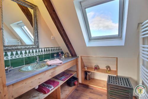 a bathroom with a sink and a mirror at Le gite riad de kerity in Paimpol
