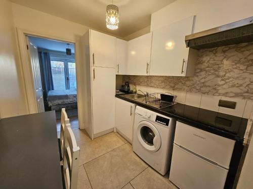 a kitchen with a washer and a washing machine at Cozy Central One Bedroom Flat in Reading
