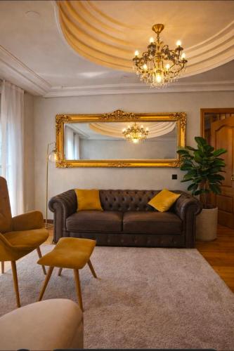 a living room with a couch and a mirror at Suite Legio VII in León