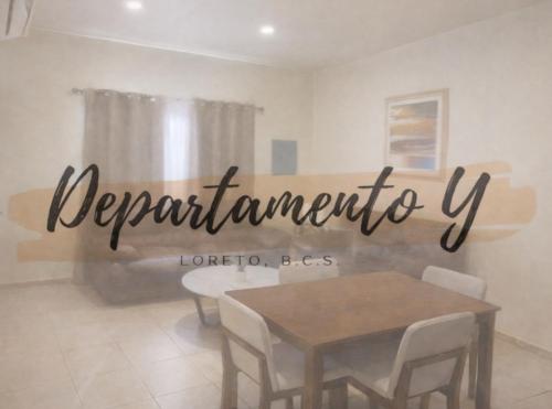 a sign in a room with a table and chairs at Departamento Y in Loreto