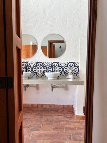 a bathroom with two sinks and a mirror at Casona El Nacional in San Gil