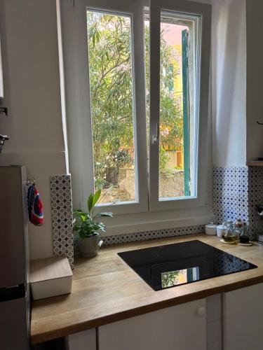 a kitchen with a counter with a window in it at HyggeWaves in Bogliasco