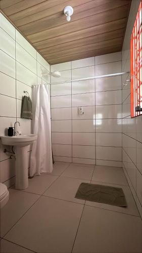 a bathroom with a sink and a shower and a toilet at Chácara Santa Maria in Itupeva
