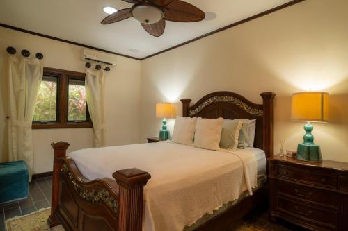 a bedroom with a bed and a ceiling fan at Casa Plazoleta 4 bdr private pool in Los Suenos in Herradura