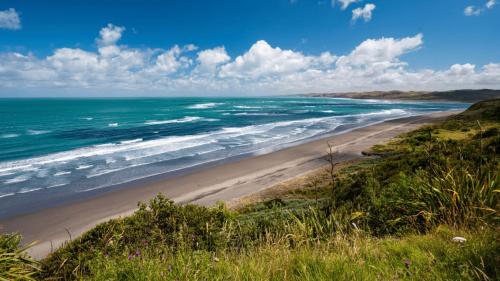a view of a beach with the ocean at Cosy Raglan Studio - Walk to Beach and Village - Roberts St - Studio Downstairs in Raglan