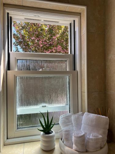 a window with a bunch of towels in front of it at 2 Bedroom Apartment 11 Minutes From Stansted Airport in Great Dunmow