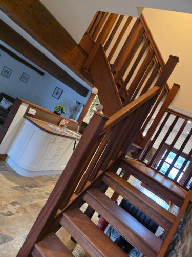a group of wooden stairs in a room at Grawen Fach in Cefn-coed-y-cymmer