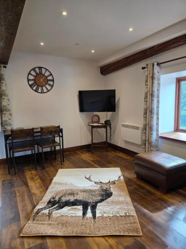 a living room with a deer rug on the floor at Grawen Fach in Cefn-coed-y-cymmer