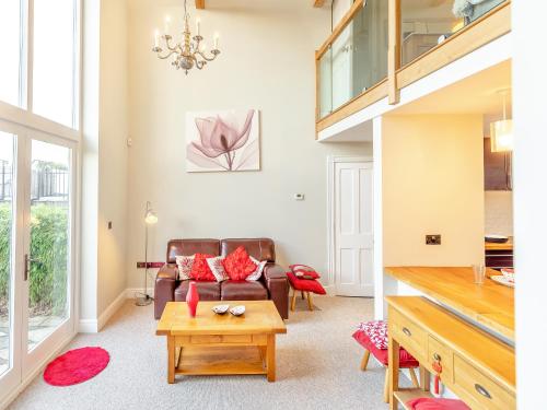 a living room with a couch and a table at Hallmark Lodge in Tenterden