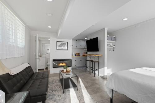 a bedroom with a bed and a living room with a fireplace at The Briarcliff Suite studio in Athens