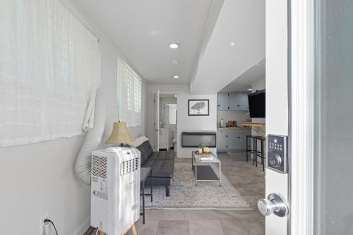 a living room with a couch and a kitchen at The Briarcliff Suite studio in Athens