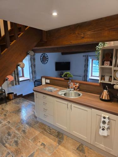 a kitchen with a sink and a counter at Grawen Fach in Cefn-coed-y-cymmer