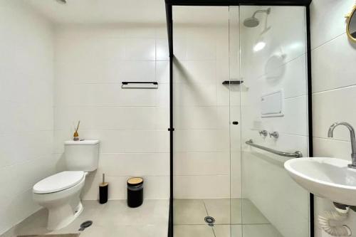 a white bathroom with a toilet and a sink at Studio Congonhas I SP Expo I Morumbis & Interlagos in São Paulo