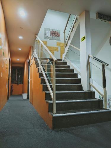a staircase in an office building with a stair case at Cahaya Hanson BilikXpert in Kuala Lumpur